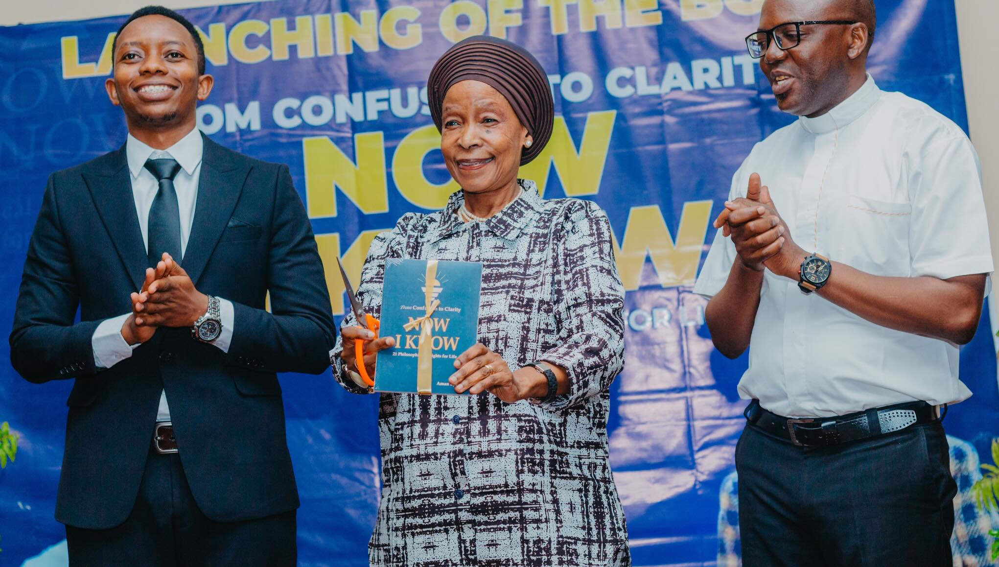 The guest of honour cuts the ribbon on the first copy.